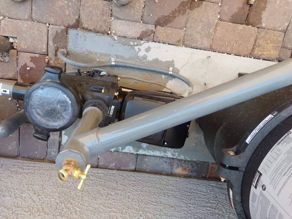 Residential pool pump, control panel and connected plumbing.