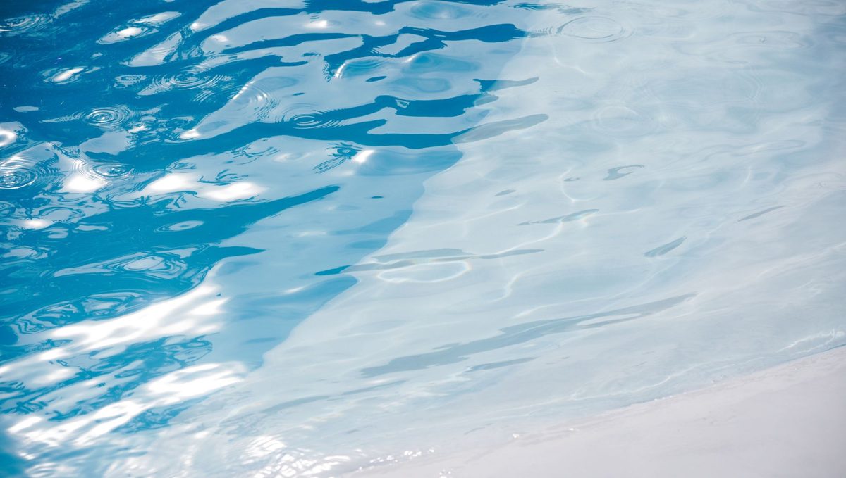 Rippling pool water over a pale pool surface.