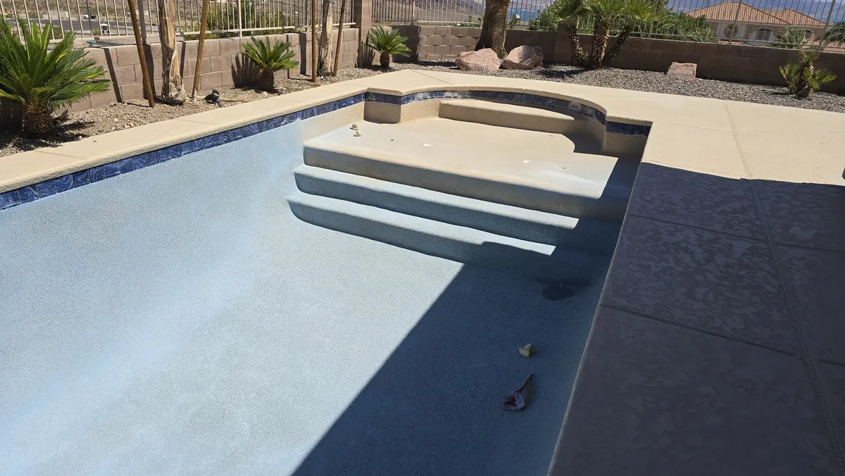 Drained pool and crew during remodeling.