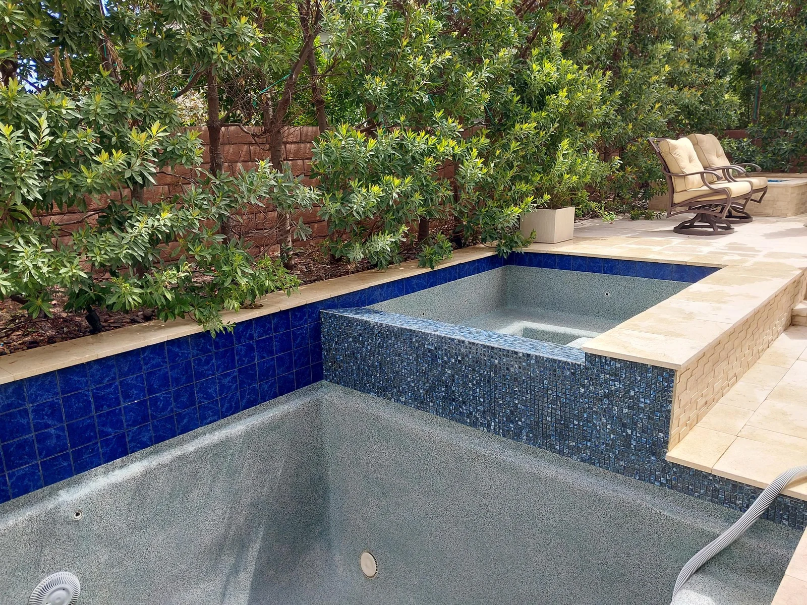 Clean blue waterline tile on a drained Las Vegas pool and spa after tile cleaning.