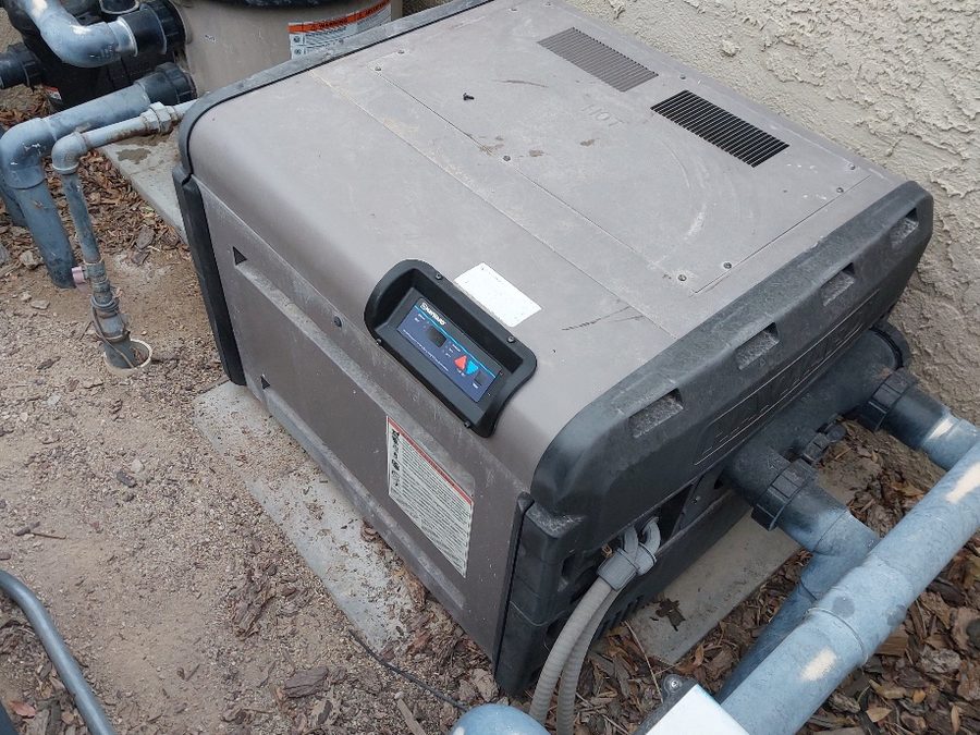Gas pool heater beside pool equipment