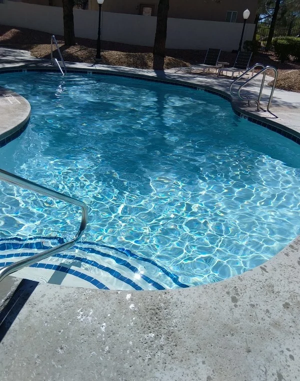Clear blue pool water over curved entry steps.