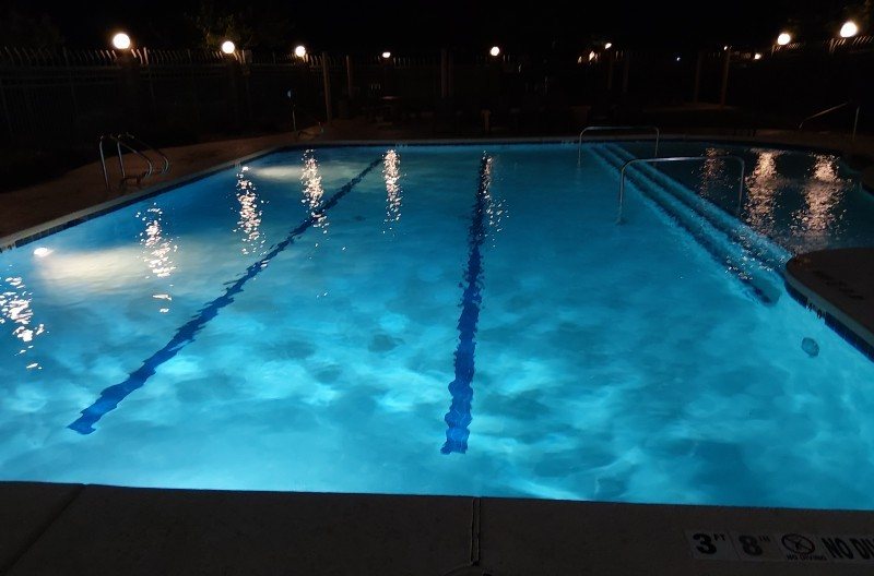 Commercial lap pool lit at night after service