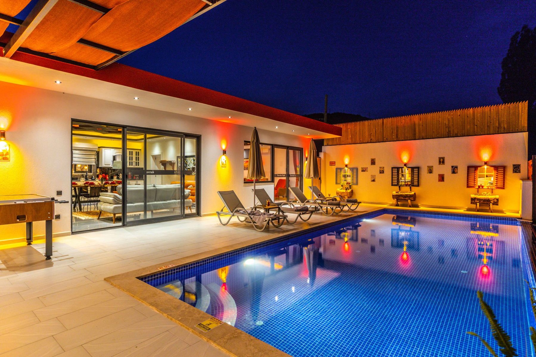 Commercial pool lit with color lighting at dusk