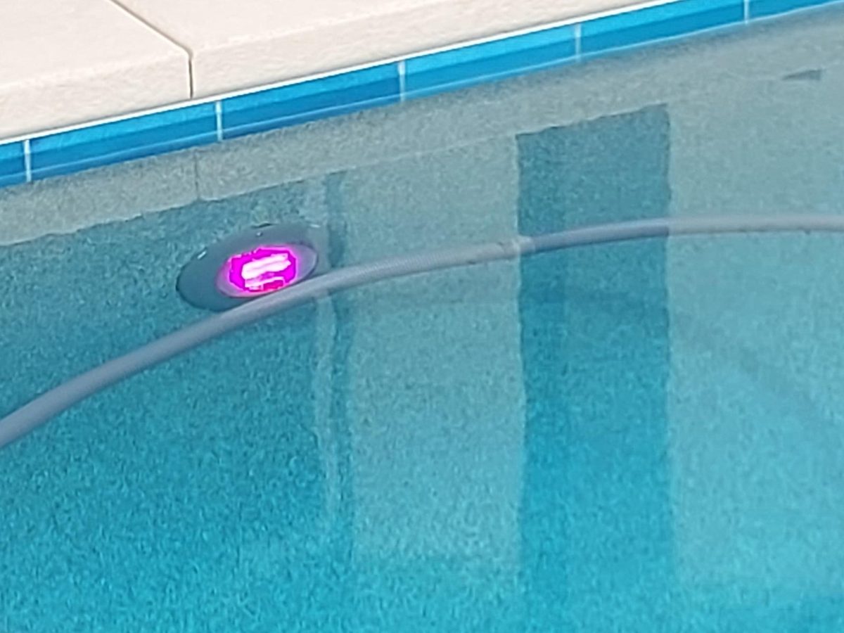 Color LED pool light in a pool wall