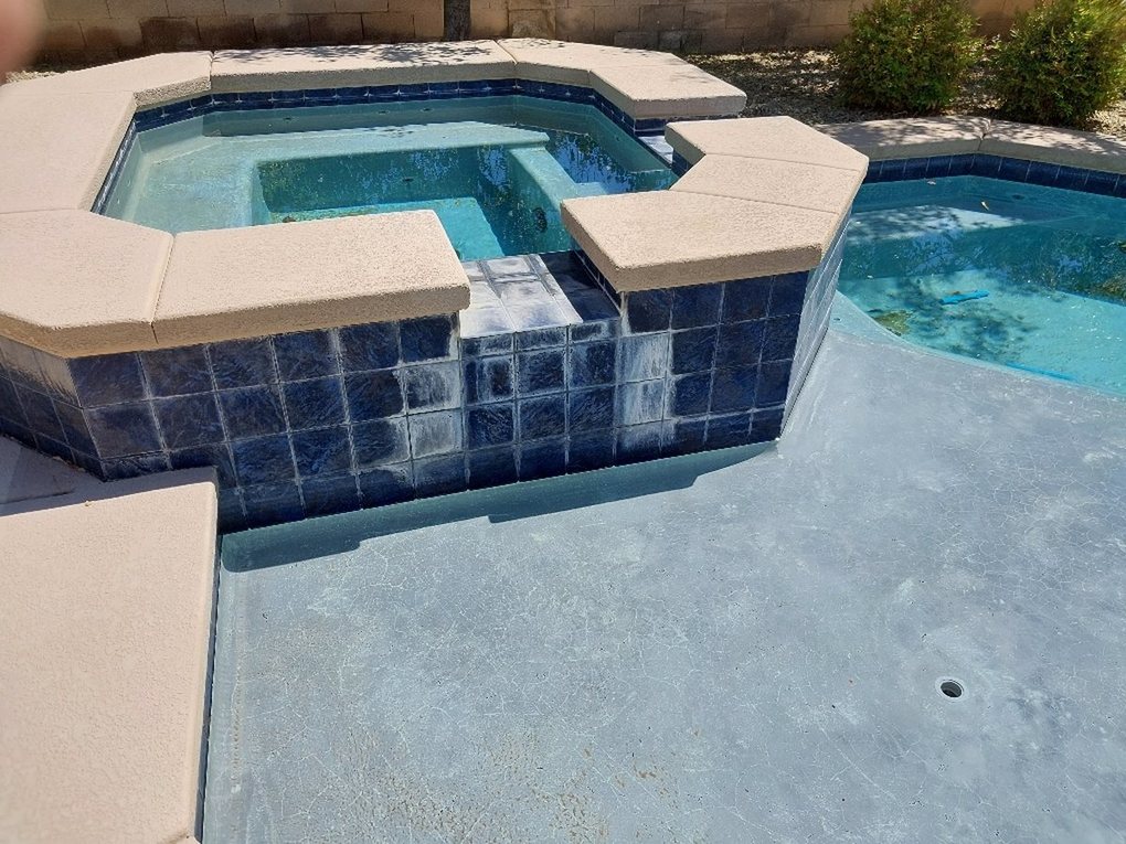 Spa tile covered in white calcium scale