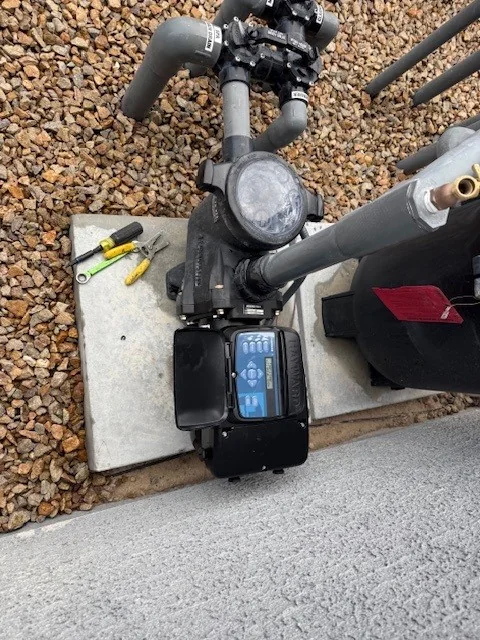 Residential pool pump, control panel and connected plumbing.