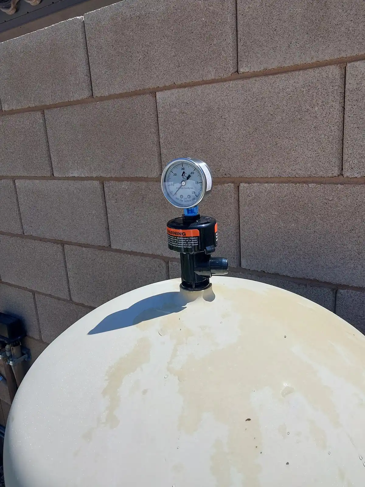Replacement pressure gauge above the filter air-release assembly.