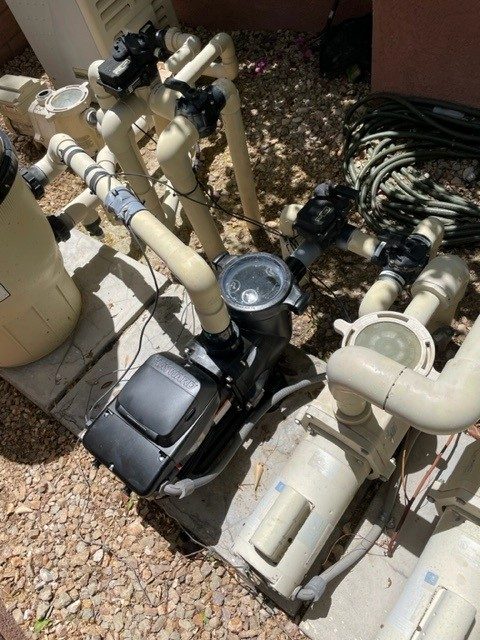 Pool pump installed beside a cartridge pool filter