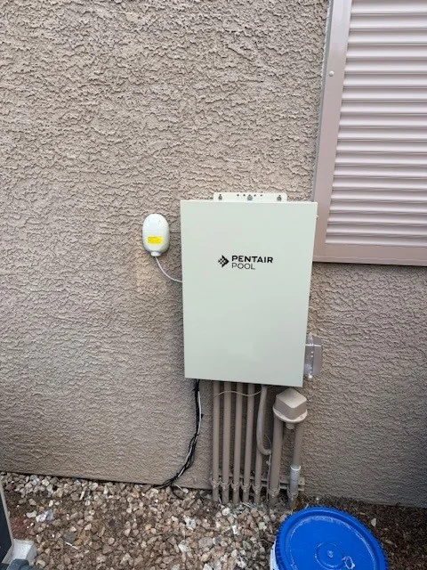 Pool automation control panel mounted beside equipment.