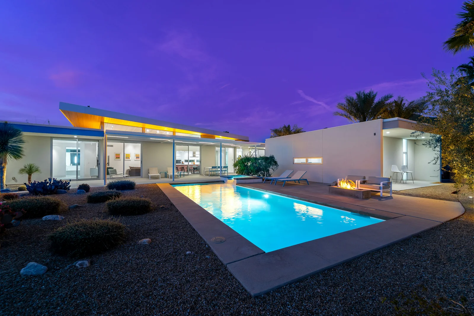 Outdoor swimming pool illuminated at night.