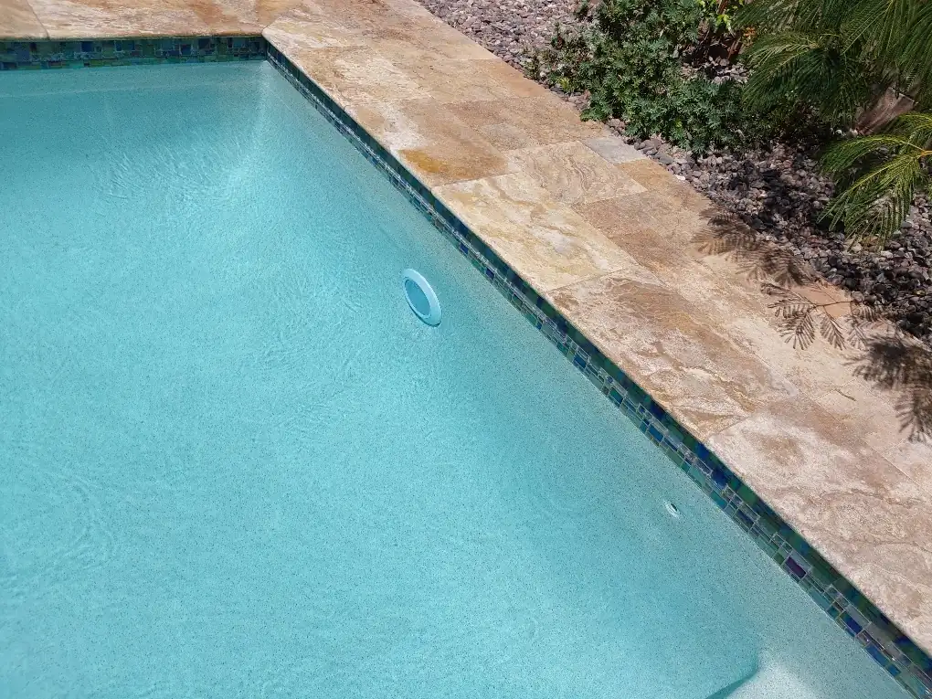 Pool wall light visible beneath blue water.