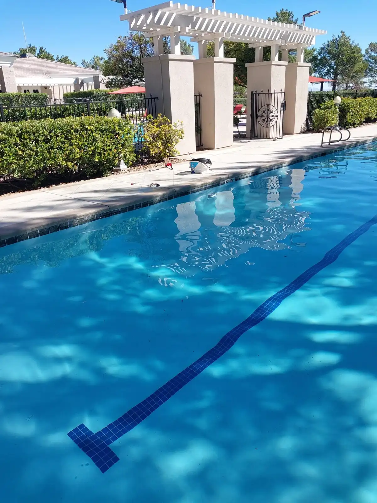 Outdoor lap pool with clear water and lane markings.