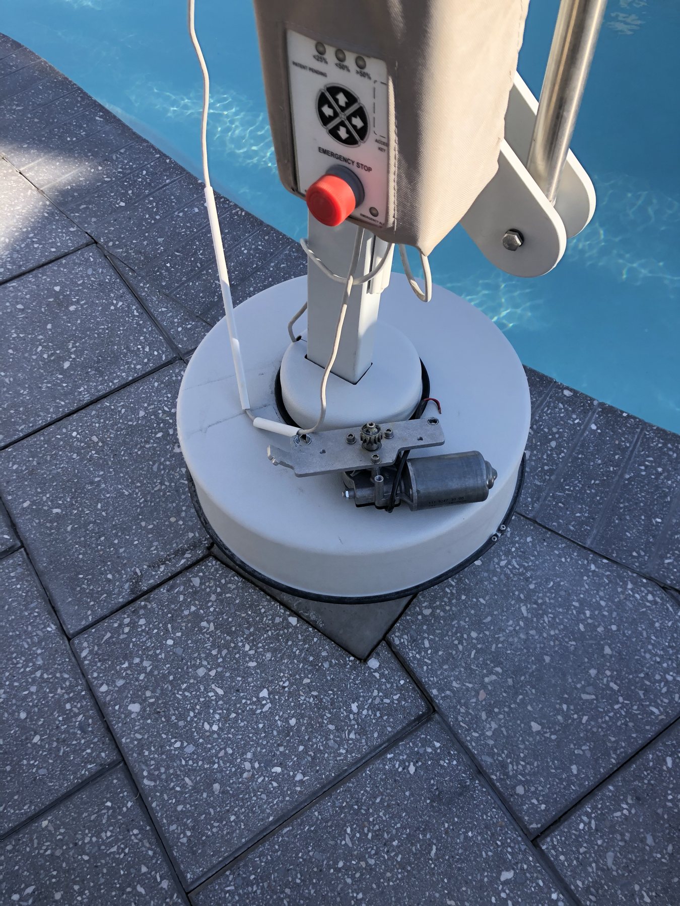 Pool lift base and anchor on a paver deck