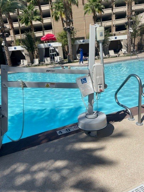 ADA pool lift installed beside a commercial pool