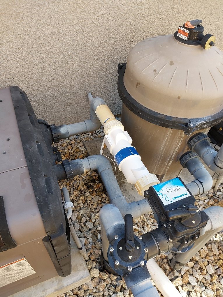 Salt cell installed beside a pool filter and pool pump