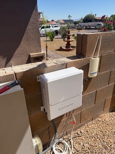 Salt system control box mounted on a block wall