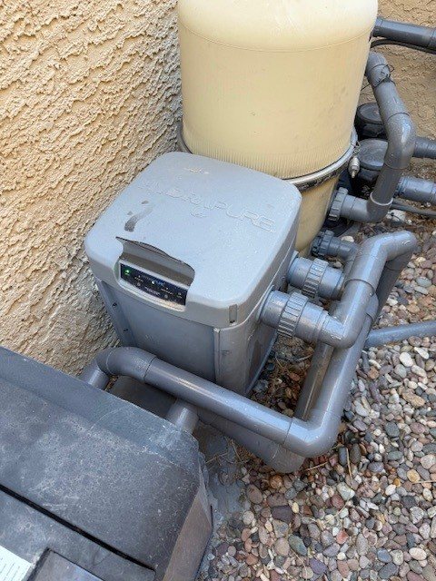 UV unit beside a pool filter and pool pump