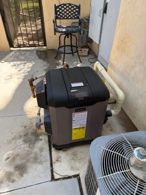 Installed pool heater and its pipe connections.