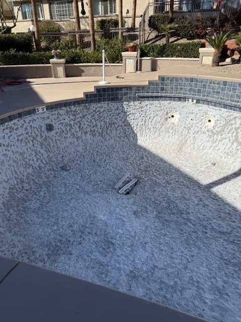 Drained pool during suction-outlet work.