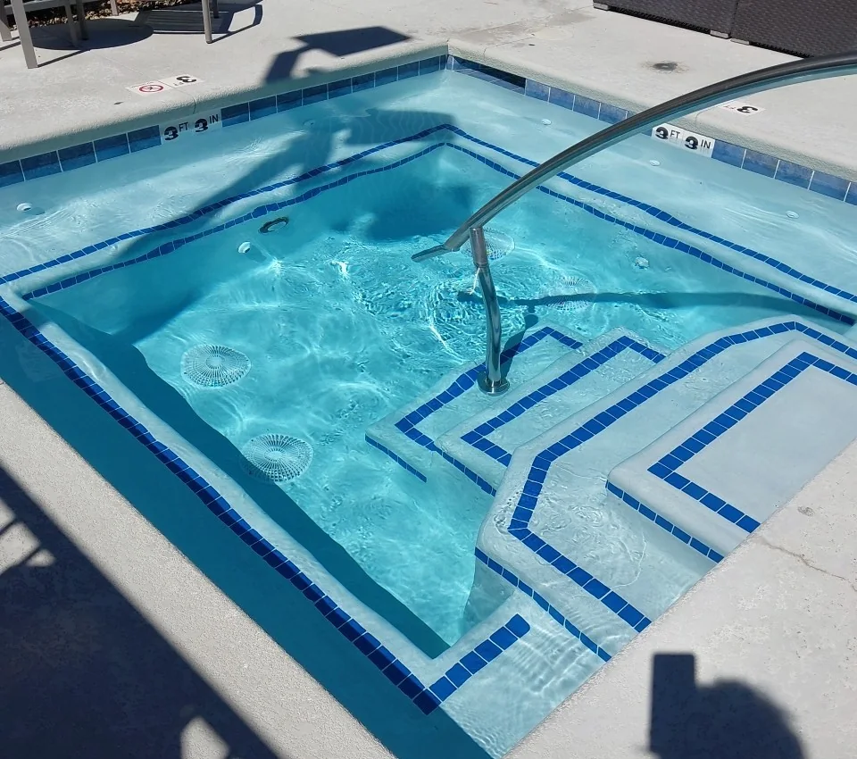 Clear spa water above curved entry steps.