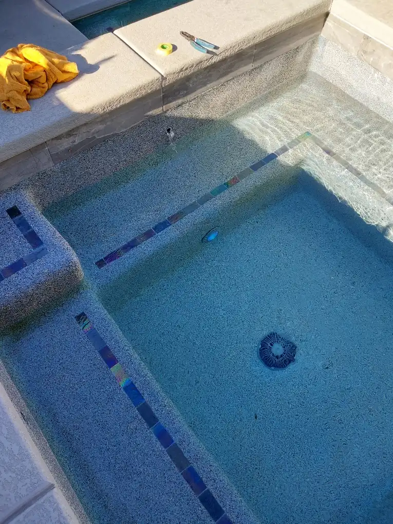 Spa entry steps and underwater light beneath the water.
