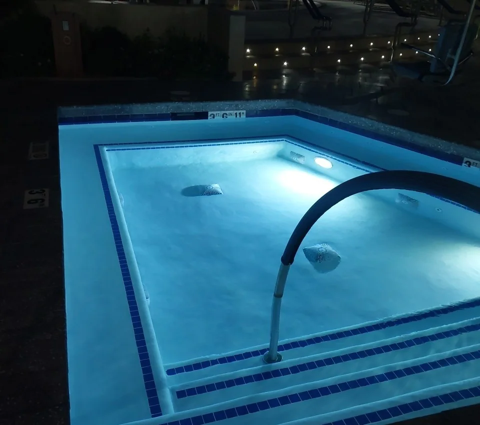 Spa illuminated by an underwater light at night.